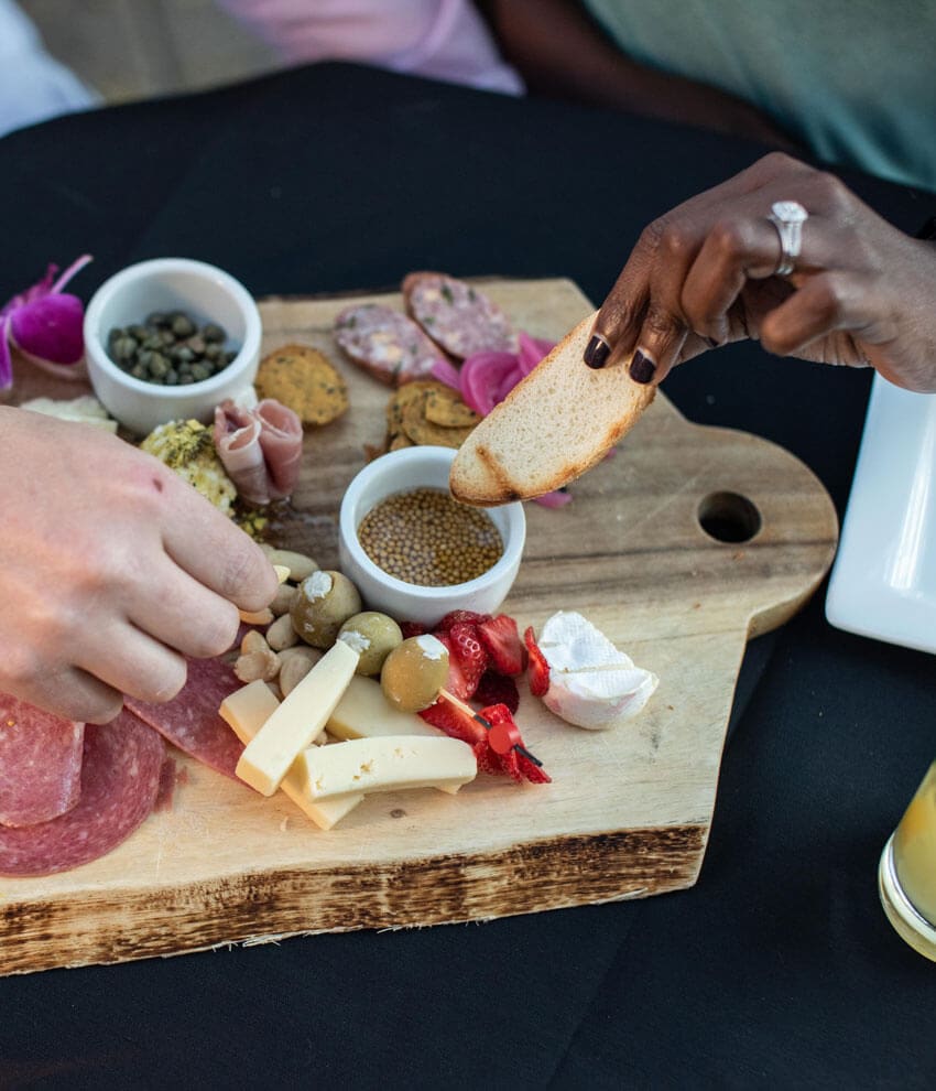 Guests dining and enjoying a charcuterie board