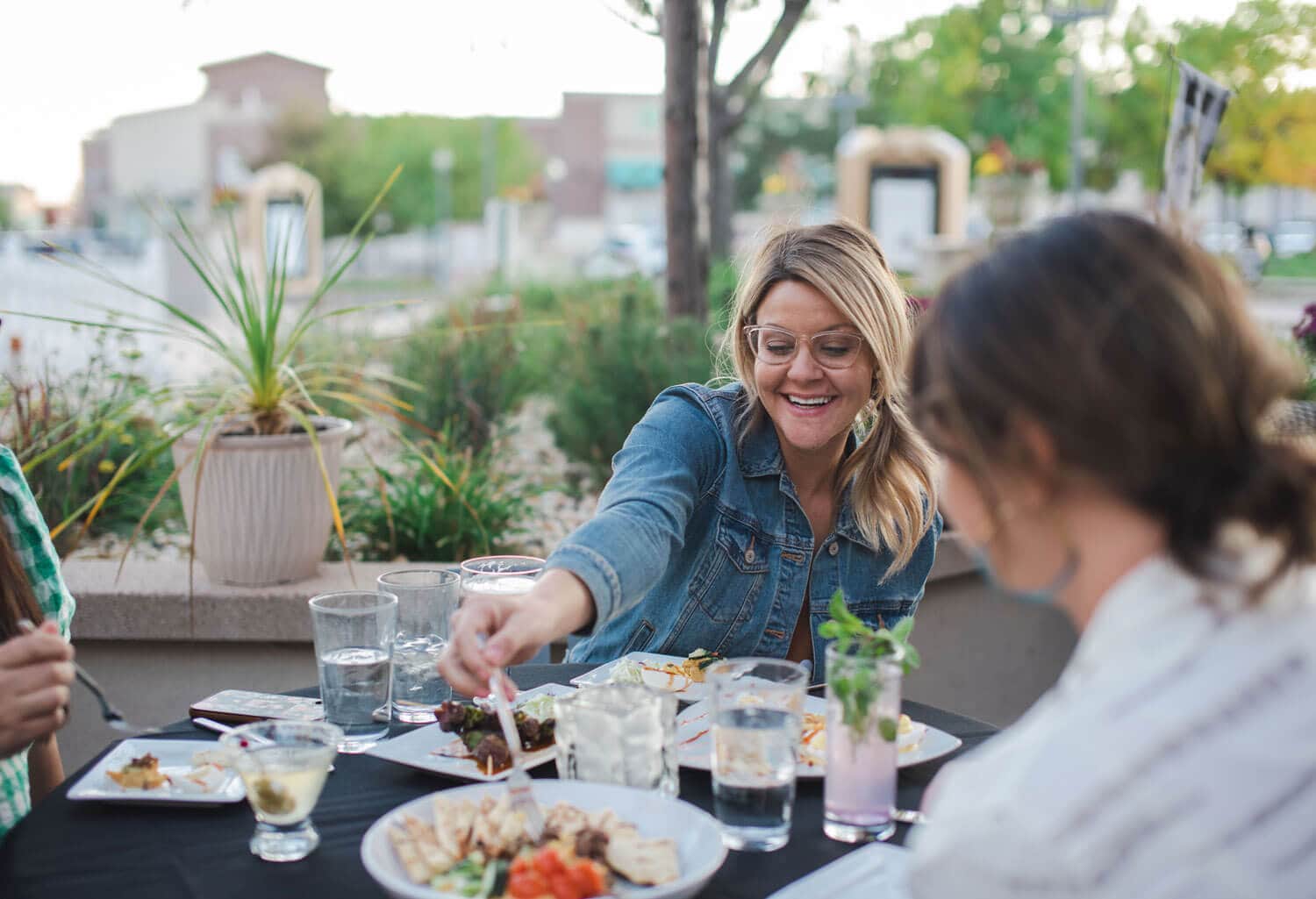 Guests eating and drinking in a restaurant on a outdoor patio