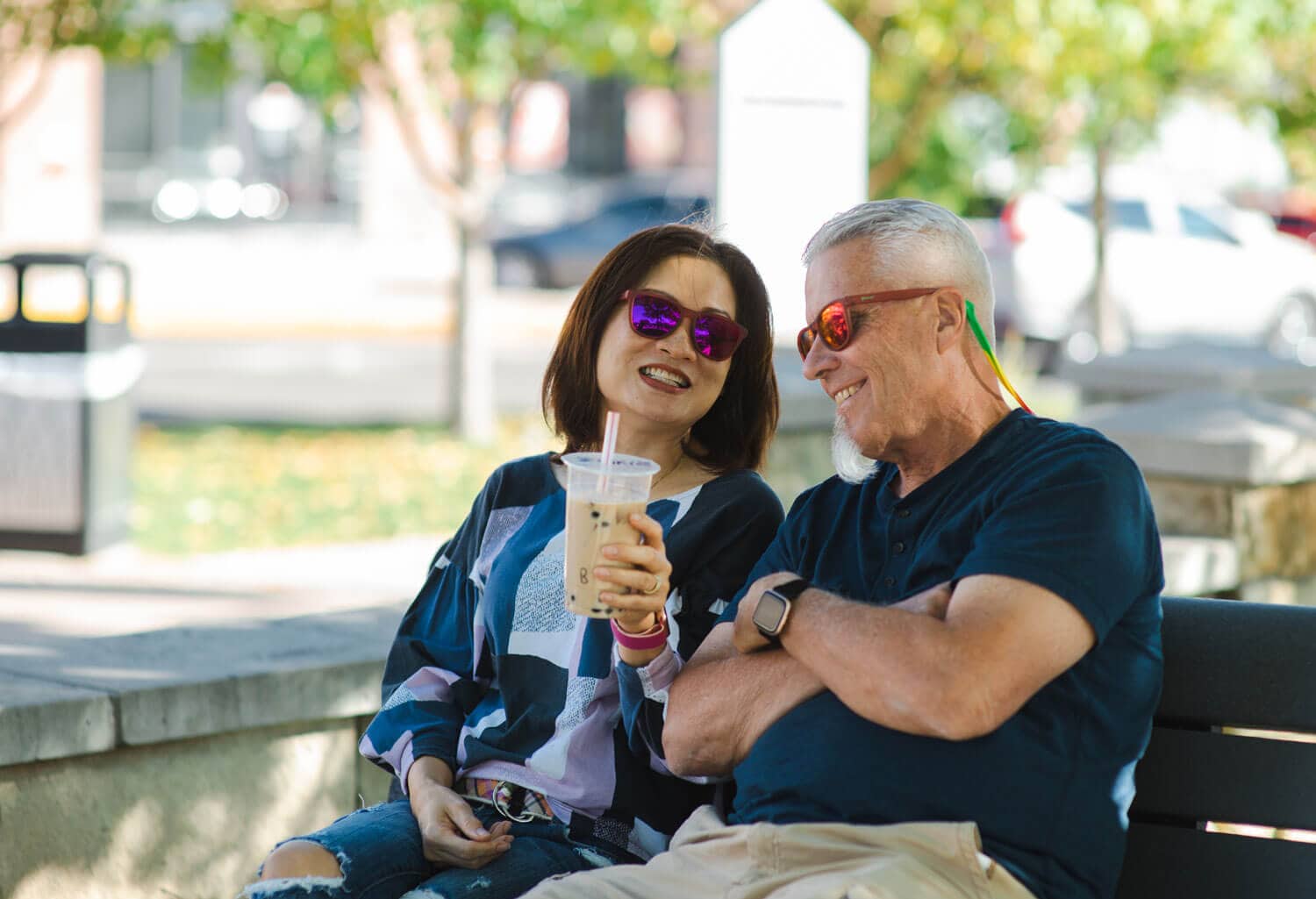 A couple sitting on a bench at the First and Main Town Center