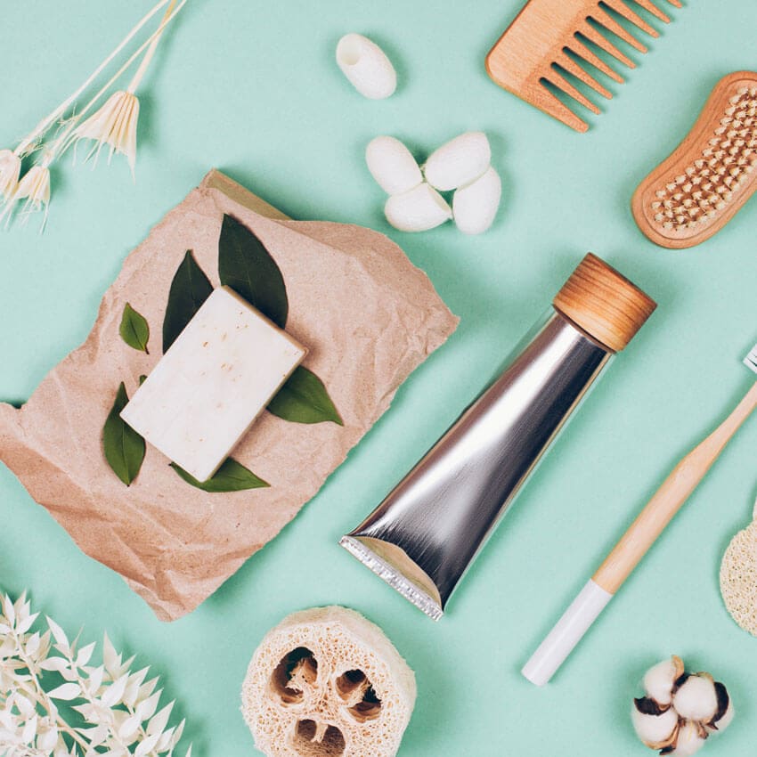 A aqua background flat-lay with an arrangement of spa products 