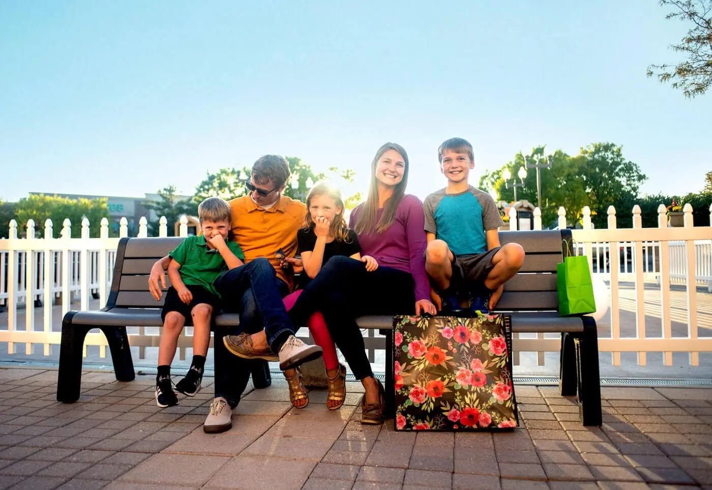 A family on a bench enjoying the First and Main Town Center